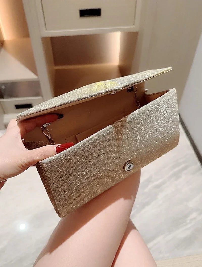 Ladies silver evening clutch bag from Mohammad Collection featuring shining, elegant design, suitable for weddings and formal occasions.
