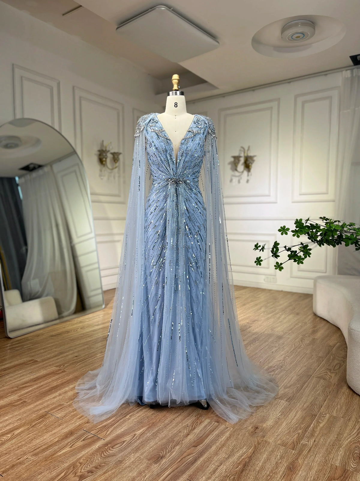 Turquoise mermaid evening dress by MC THE BLACK DIAMOND with elegant fit and flowing fabric, designed for formal occasions.