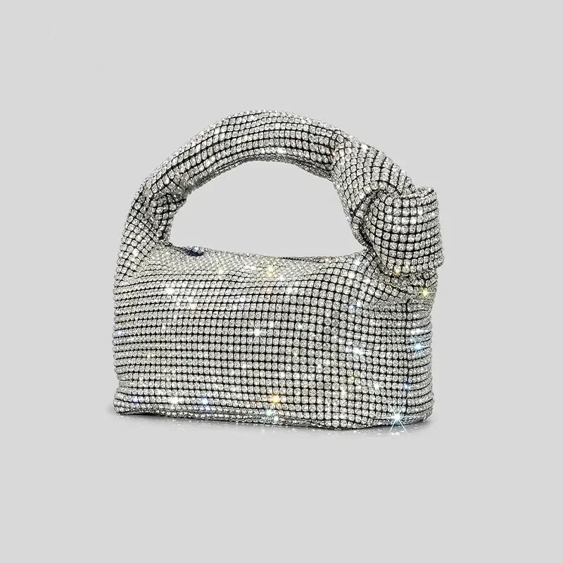 Silver crystal handle evening bag by MC THE BLACK DIAMOND with rhinestone knot detail and top handle for women’s luxury purses.