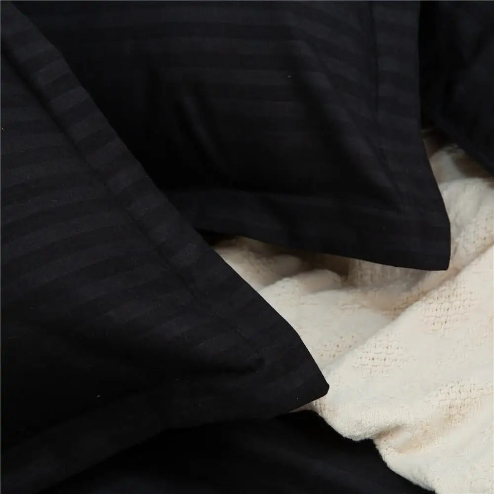 Black quilt set by MC THE BLACK DIAMOND, double to king size bedding with solid color comforter and duvet cover for a cozy bedroom look.