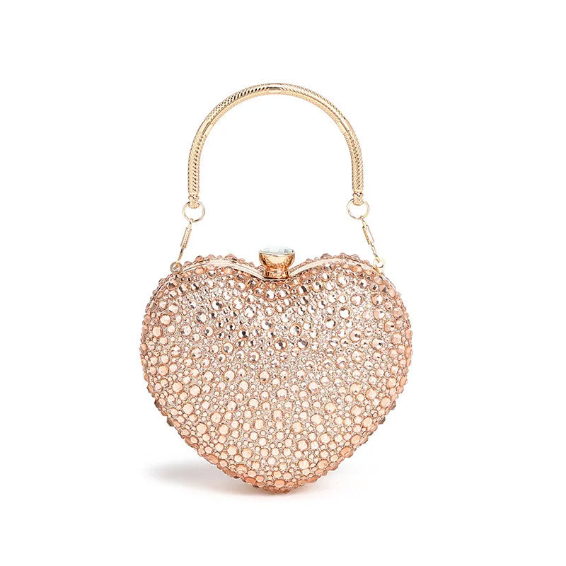 Luxury diamond inlay heart-shaped crystal clutch purse by MC THE BLACK DIAMOND, featuring rhinestone embellishments and a shoulder handle.