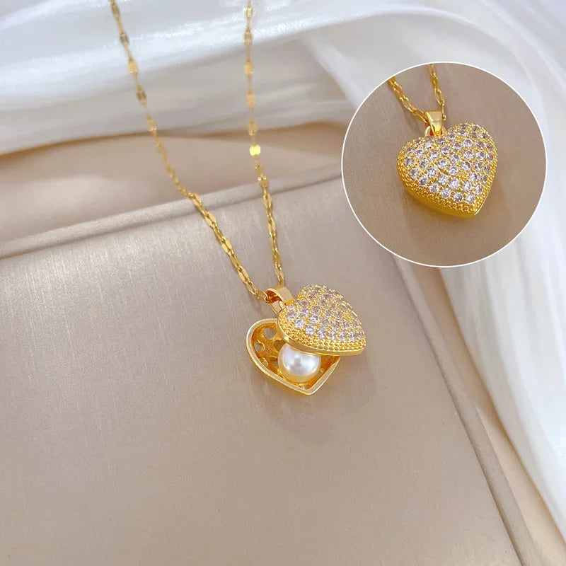 ZAKOL gold-colored stainless steel shell pearl necklace with love heart pendant, perfect for women’s wedding or casual jewelry.