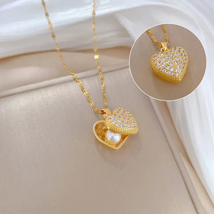 ZAKOL gold-colored stainless steel shell pearl necklace with love heart pendant, perfect for women’s wedding or casual jewelry.