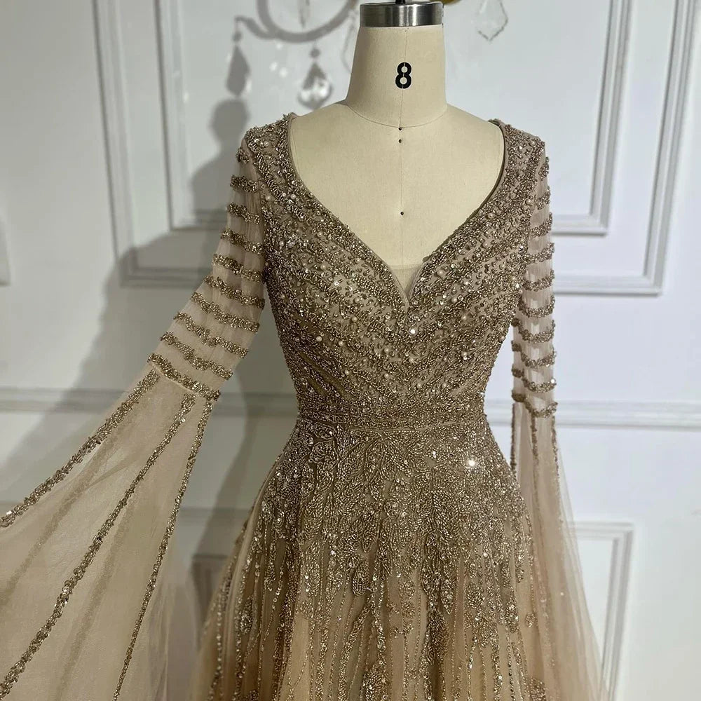 Elegant MC BRAND Arabic caramel-colored dress by MC THE BLACK DIAMOND, showcasing intricate design and flowing fabric.