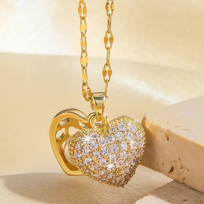 Gold ZAKOL French shell pearl necklace for women featuring a love heart pendant and zircon accents, made of stainless steel.
