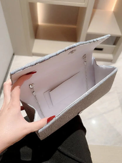 Ladies silver evening clutch bag with shining finish, crossbody strap, ideal for weddings and formal events, by Mohammad Collection.