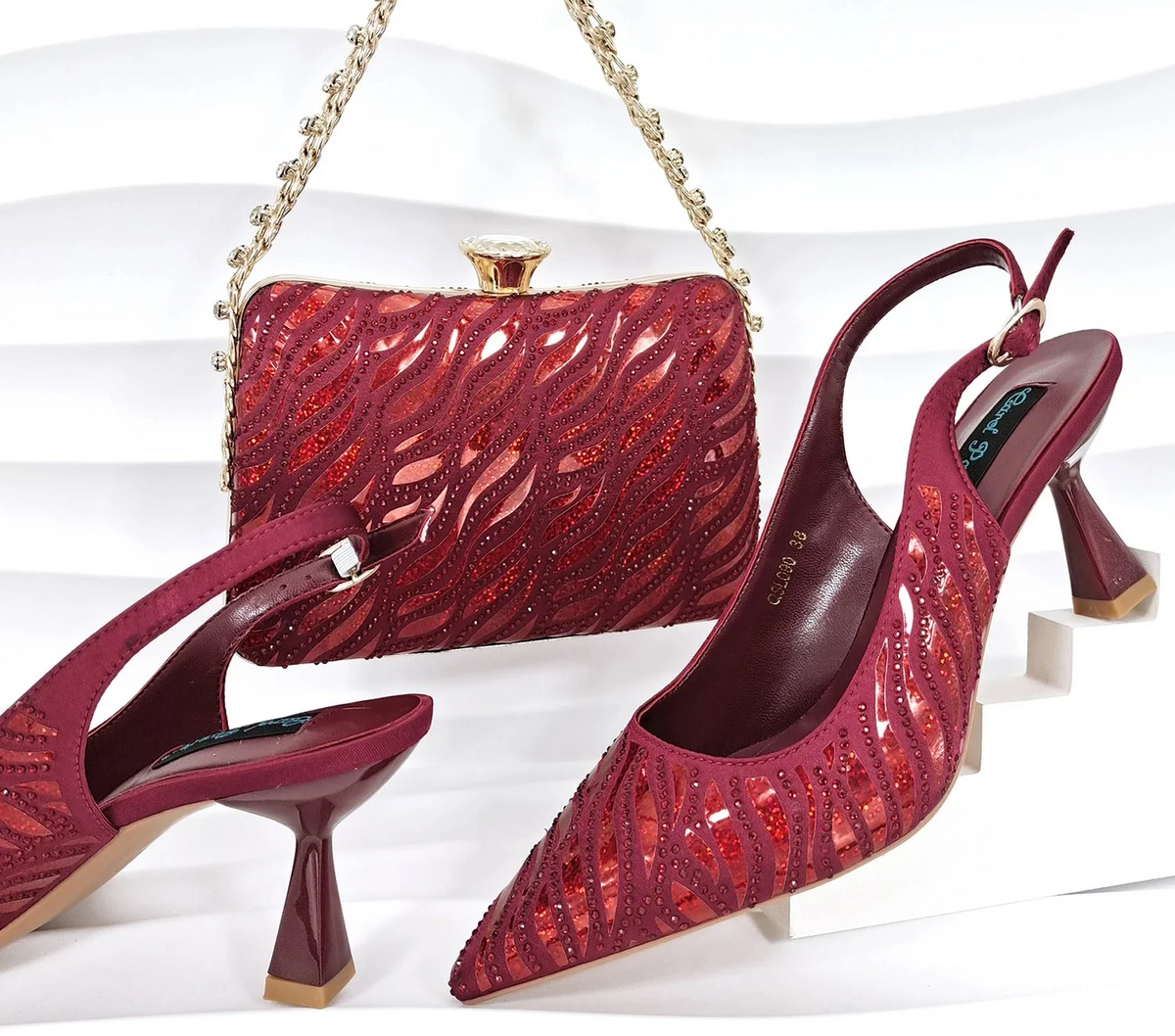 Nigerian style women heels and shiny clutch by MC THE BLACK DIAMOND, featuring pointed toe stiletto shoes and elegant party accessories.