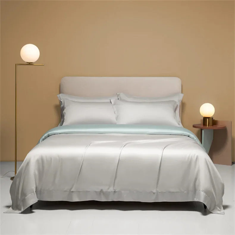 Luxury Mulberry Silk duvet cover in solid color, displayed on a bed with high-quality bedsheets by 𝕄𝕔 𝕋𝕙𝕖 𝔹𝕝𝕒𝕔𝕜 𝔻𝕚