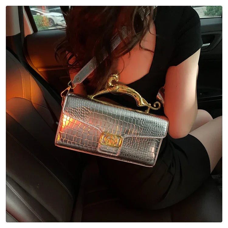 Women’s luxury MC THE BLACK DIAMOND leather hand bag with metal buckle, simple fashion shoulder bag for parties and everyday use.