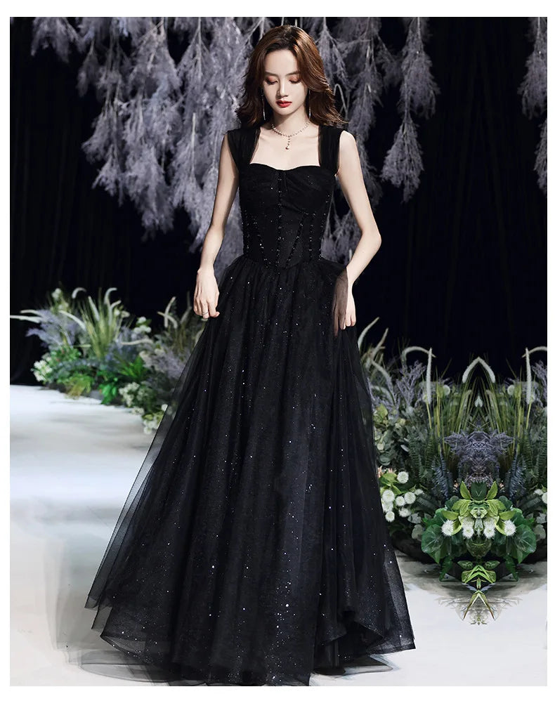 Black evening dress for women by MC THE BLACK DIAMOND, showcasing elegant design and flowing fabric suitable for formal occasions.