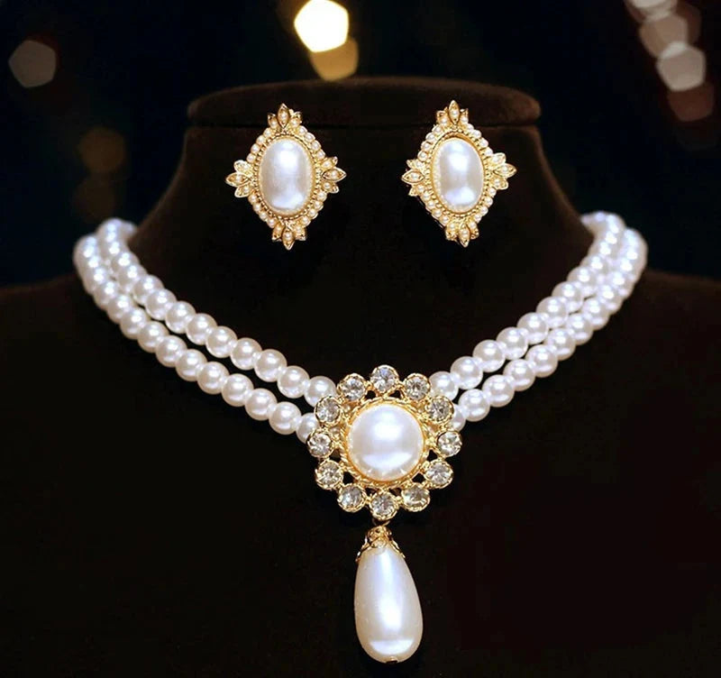 Elegant vintage pearl pendant necklace and matching earrings from Mc The Black Diamonds, featuring classic pearl and chain designs.