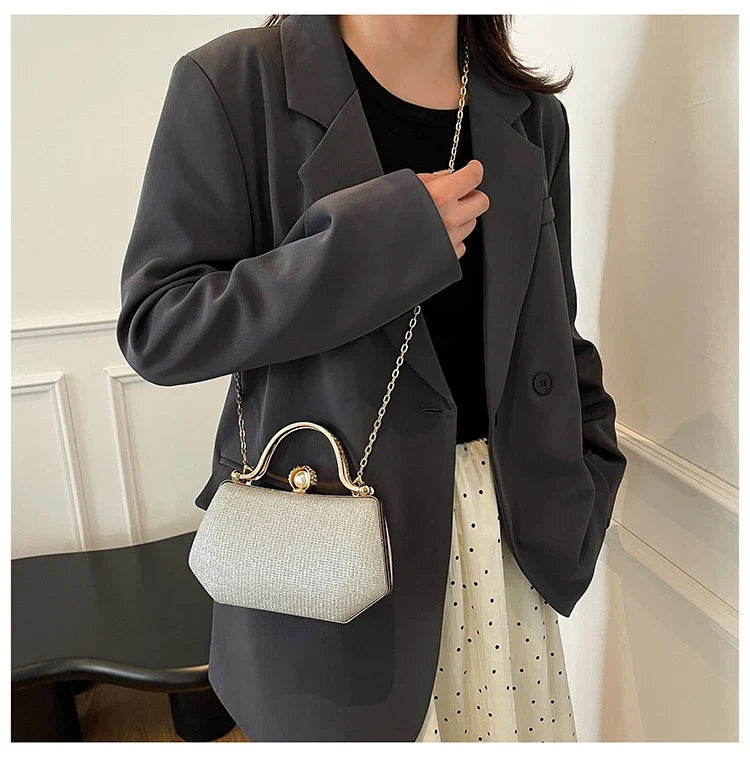 Black MC The Diamonds hand bag with a solid color, chain strap, and simple crossbody design for versatile evening wear.