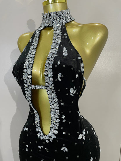 Sparkly velvet MC THE BLACK DIAMOND dress with long sleeves and fitted silhouette, shown on a hanger.