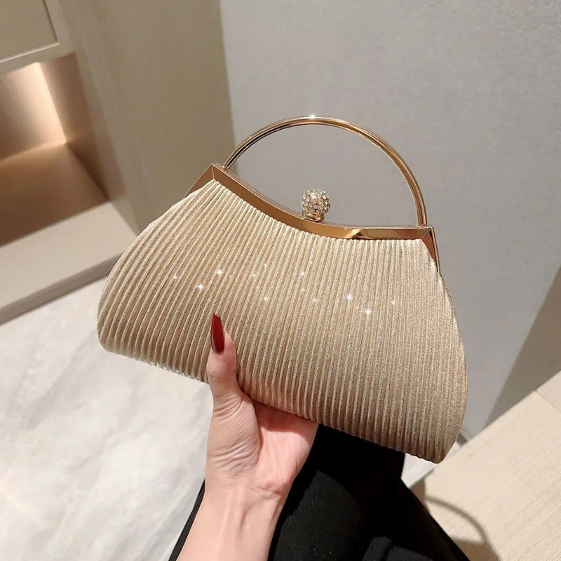 Gold MC THE BLACK DIAMOND pleated evening handbag with top handle, glitter clutch design, diamond accents, perfect for wedding or party.
