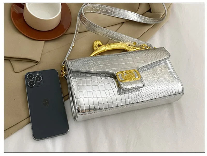 Women’s luxury leather shoulder bag by MC THE BLACK DIAMOND with metal buckle, simple elegant design, ideal for parties and everyday use.