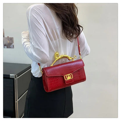 Women’s luxury MC THE BLACK DIAMOND leather handbag with metal buckle, simple fashion shoulder bag for parties and stylish occasions.