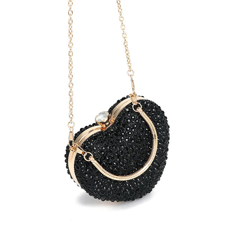 Luxury MC THE BLACK DIAMOND heart-shaped crystal clutch bag with diamond inlay, rhinestones, and a shoulder handle for evening or wedding parties.