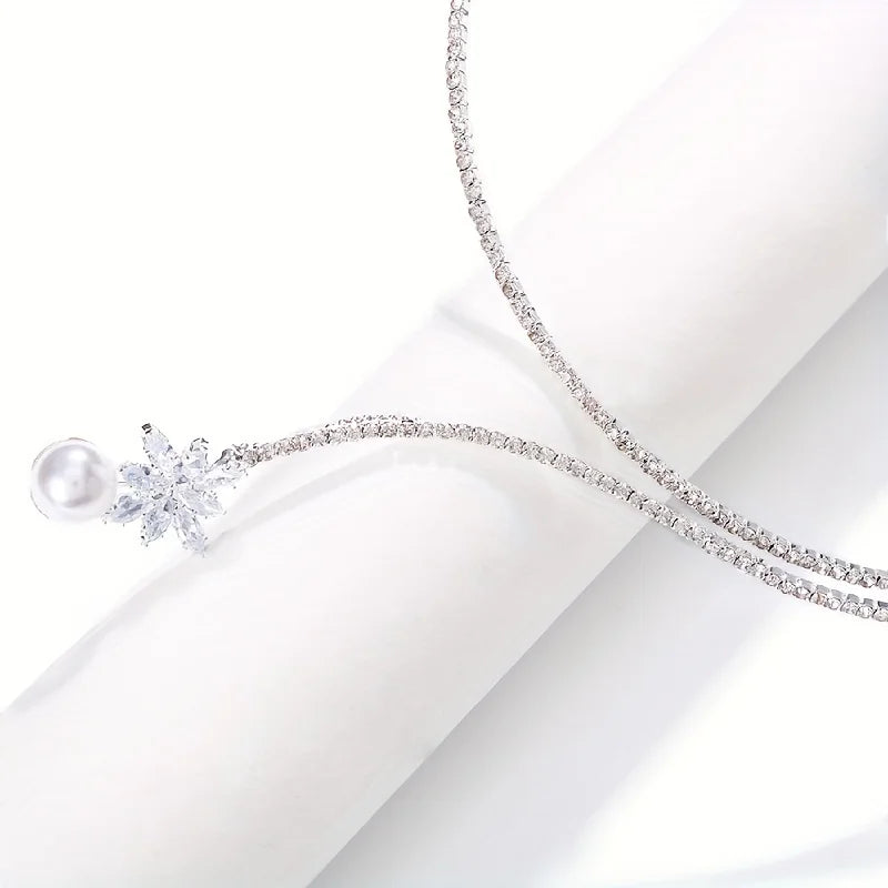 Elegant vintage-inspired pearl and zirconia flower pendant necklace featuring intricate design, ideal for bridal and special occasions.