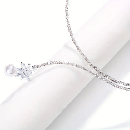 Elegant vintage-inspired pearl and zirconia flower pendant necklace featuring intricate design, ideal for bridal and special occasions.