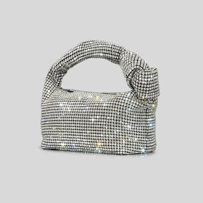 Silver crystal handle evening bag by MC THE BLACK DIAMOND with rhinestone knot detail and top handle for women’s luxury purses.