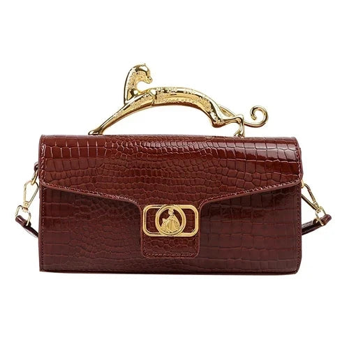 Women’s luxury leather shoulder bag by MC THE BLACK DIAMOND featuring a metal buckle and simple fashion design for parties.
