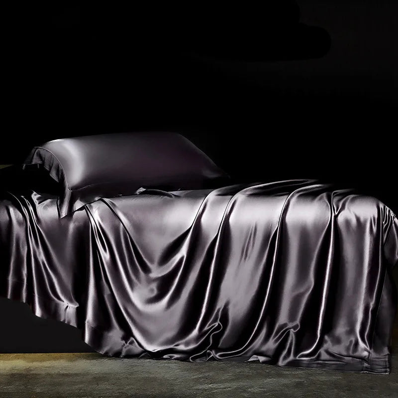 Solid black silk bedding set with duvet cover, flat and fitted sheets, pillowcases, and bedspreads for single or double beds.