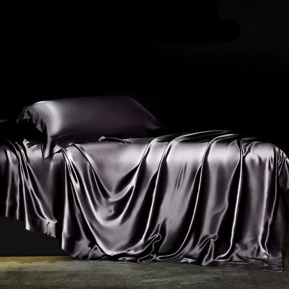 Solid black silk bedding set with duvet cover, flat and fitted sheets, pillowcases, and bedspreads for single or double beds.