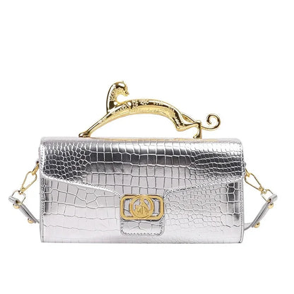 Women luxury leather shoulder bag by MC THE BLACK DIAMOND featuring a metal buckle and simple elegant design for fashionable parties.