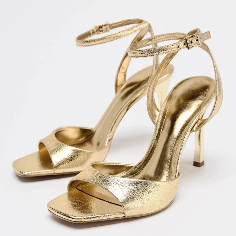 Gold patent leather ankle buckle high heel sandals for women by MC THE BLACK DIAMOND, featuring stylish straps and a sleek heel.