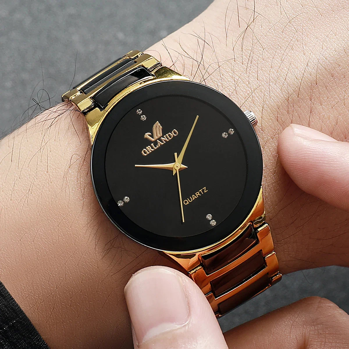 Pair of MC The Black Diamonds his and hers matching watches with black and silver designs, featuring sleek watch faces and metal bands.