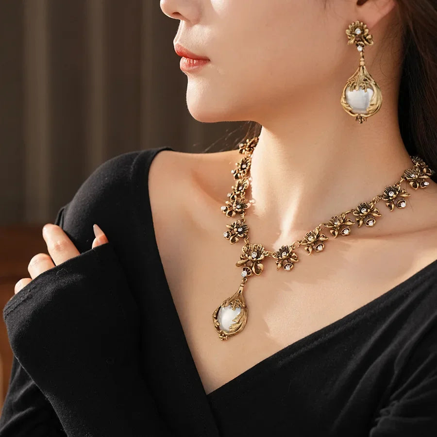 Vintage light luxury jewelry set with flower pendant, pearl earrings, and high-end retro necklace by Mohammad Collection.