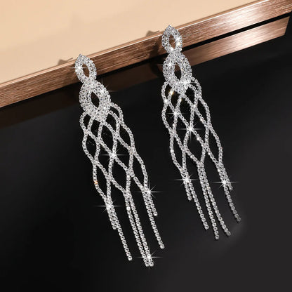 MC THE BLACK DIAMOND long tassel rhinestone drop earrings with hollow geometric design and crystal dangles for women.