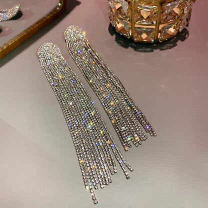MC THE BLACK DIAMOND long tassel rhinestone drop earrings with oversized crystal dangles for women, fashionable jewelry accessories.