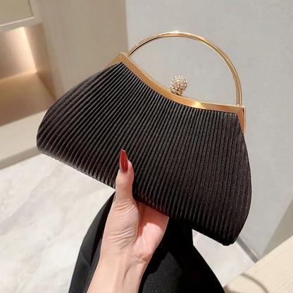 Gold MC THE BLACK DIAMOND pleated evening clutch handbag with top handle, glitter accents, diamond details, ideal for wedding or party.