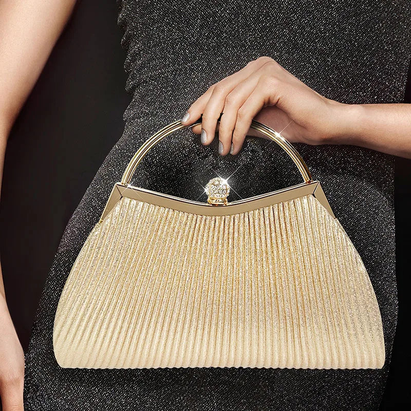 Gold MC THE BLACK DIAMOND pleated evening clutch handbag with top handle, glitter accents, perfect for wedding or party occasions.