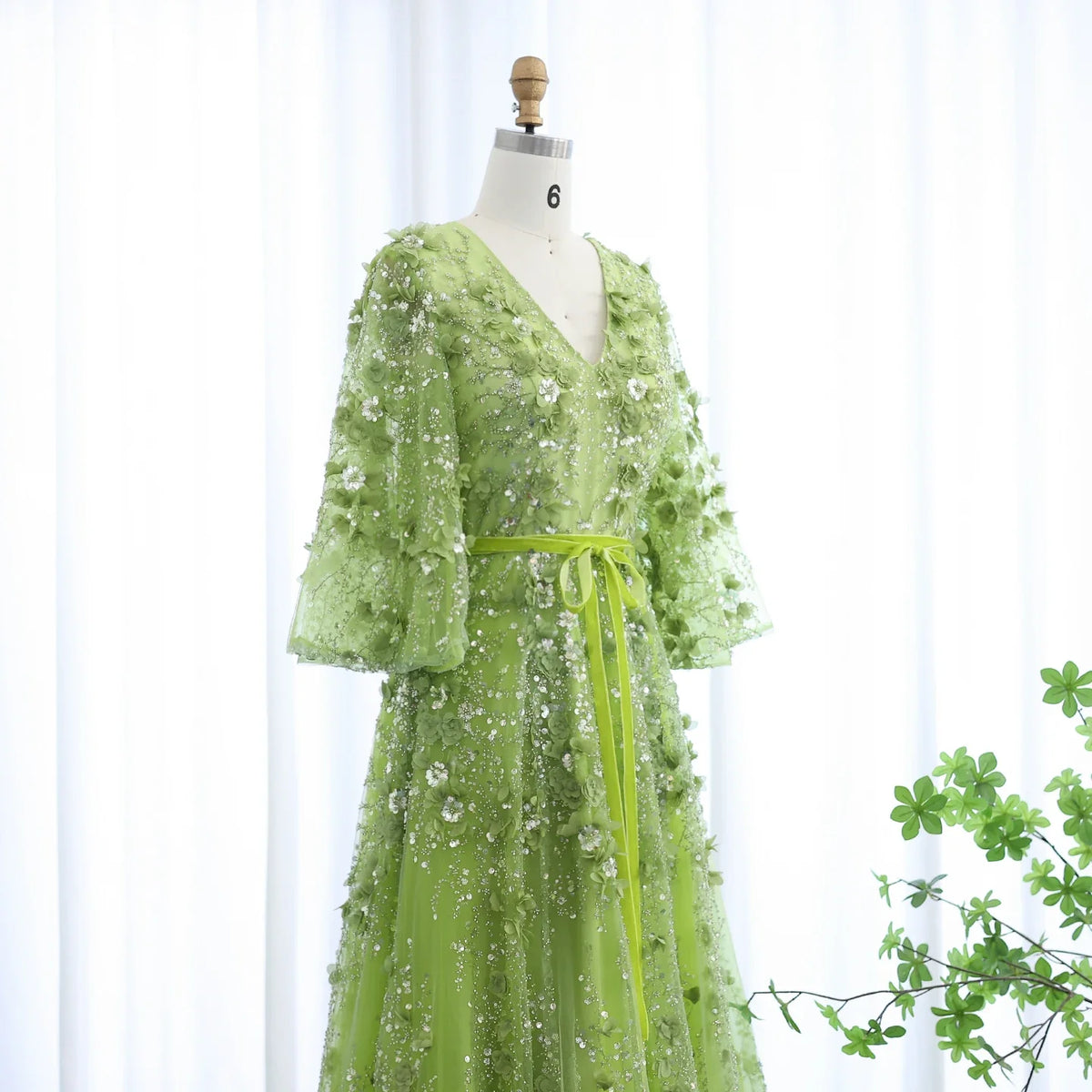 Elegant Dubai luxury dress by MC THE BLACK DIAMOND featuring intricate embroidery and flowing fabric, showcased on a mannequin.