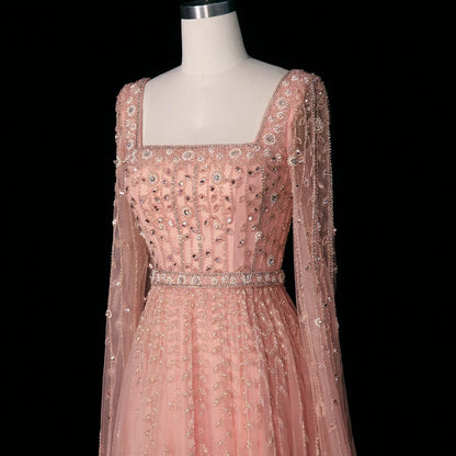 Elegant MC THE BLACK DIAMOND pink Dubai evening dress with intricate detailing and flowing fabric, perfect for formal occasions.