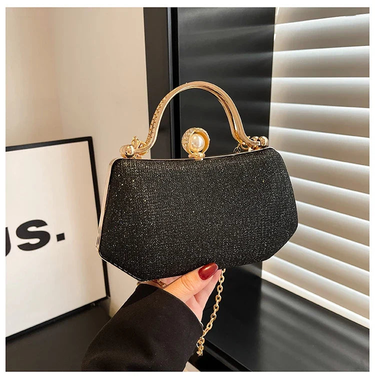 Black MC The Black Diamonds hand bag with solid color, chain strap, and simple crossbody design for versatile evening wear.
