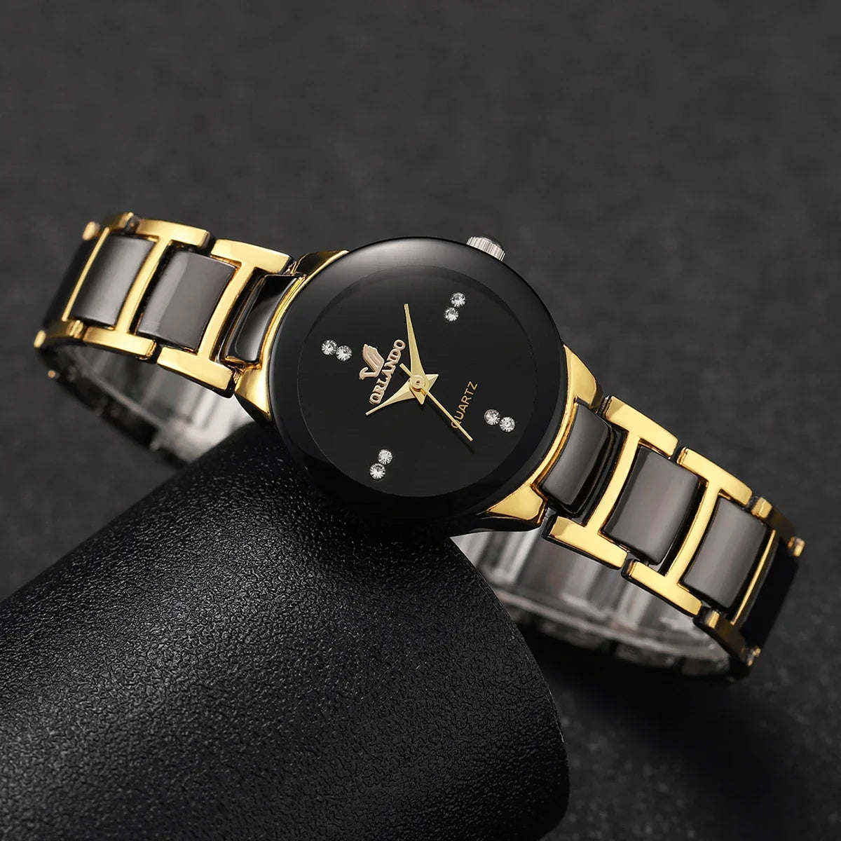 Pair of MC The Black Diamonds his and hers matching watches with black straps and sleek round dials, showcasing elegant timepieces.