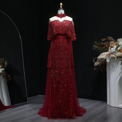 Elegant grey Arabic evening dress by MC THE BLACK DIAMOND, beaded details, flowing fabric, perfect for special occasions