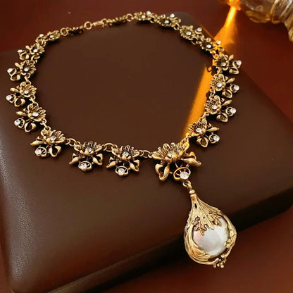 Vintage light luxury jewelry set with rhinestone flower pendant, pearl earrings, and high-end necklace for women.