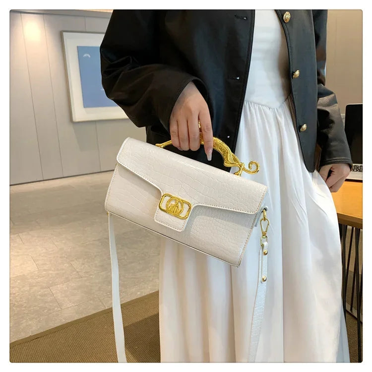 Women’s luxury leather shoulder bag by MC THE BLACK DIAMOND featuring a metal buckle, simple design, ideal for parties and stylish outings.