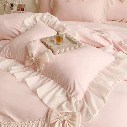 Three-piece white bedding set with ruffled duvet cover from MC The Black Diamonds, showcasing soft bedsheets and elegant design.