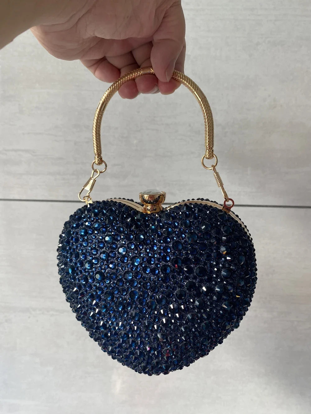 Luxury MC THE BLACK DIAMOND diamond inlay heart-shaped crystal clutch bag with rhinestone embellishments and shoulder strap for evening events.