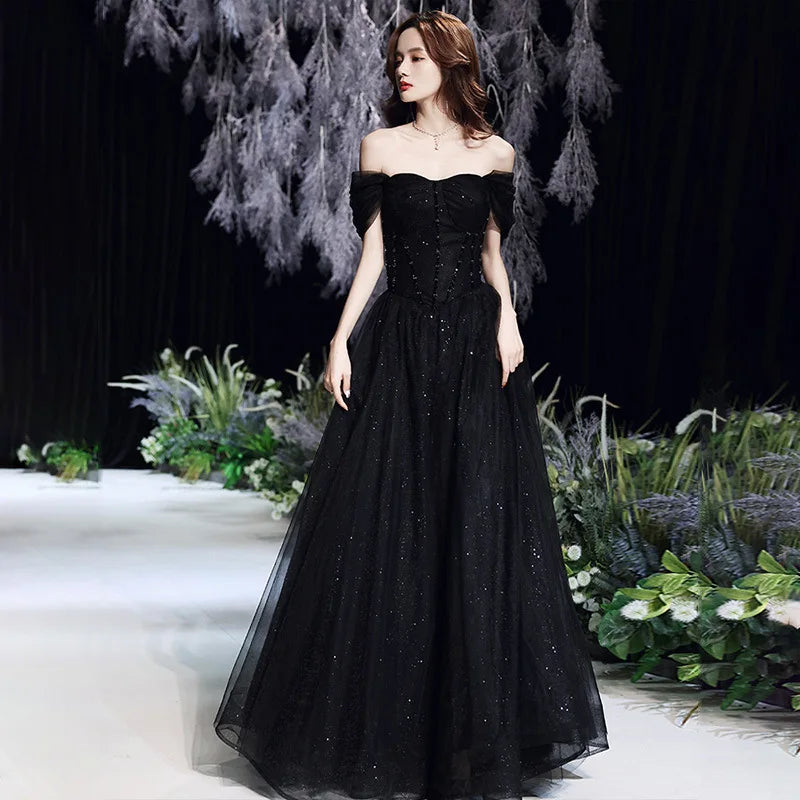 Black evening dress for women by MC THE BLACK DIAMOND, elegant full-length dress with a fitted silhouette and stylish design.