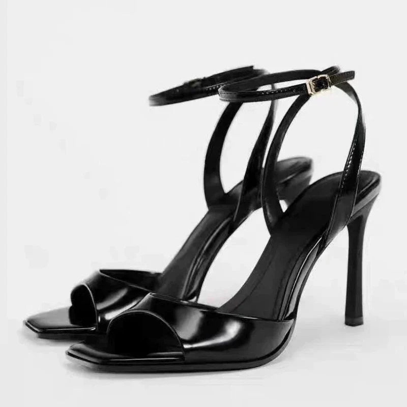 Gold patent leather ankle buckle high heel sandals for women by MC THE BLACK DIAMOND, featuring a sleek design and stiletto heel.