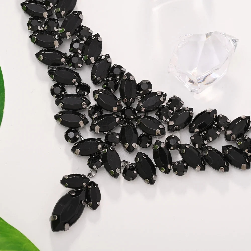 Black leaves jewelry set by MC THE BLACK DIAMOND featuring crystal bridal necklace and earrings with boho rhinestone design