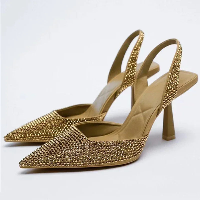 Women fashion crystal buckle slingback high heels by MC The Black Diamonds, featuring elegant heels with crystal adornments and ankle straps.