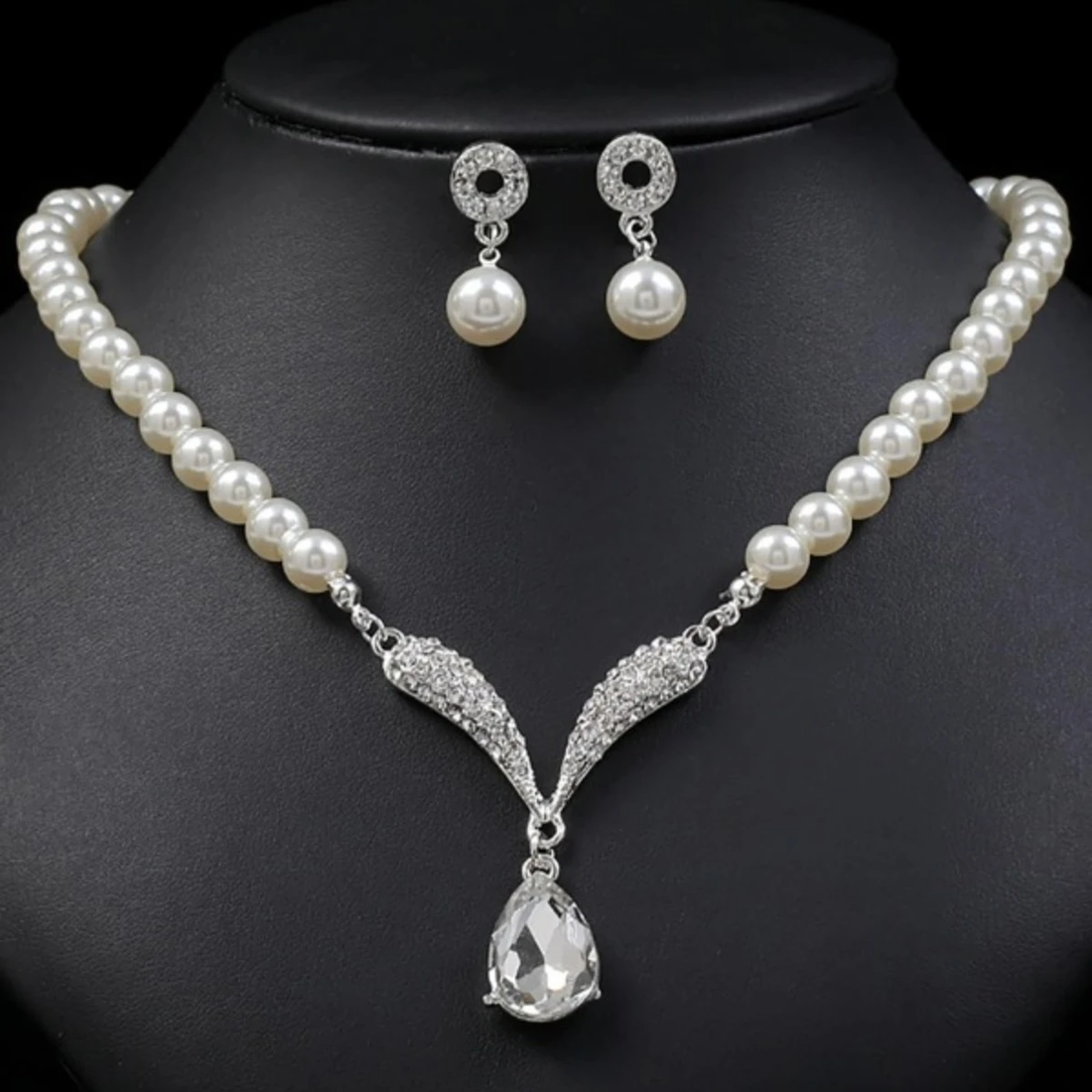 Gold jewelry set with pearl droplet necklace and matching earrings from Mohammad Collection, perfect for weddings and special occasions.