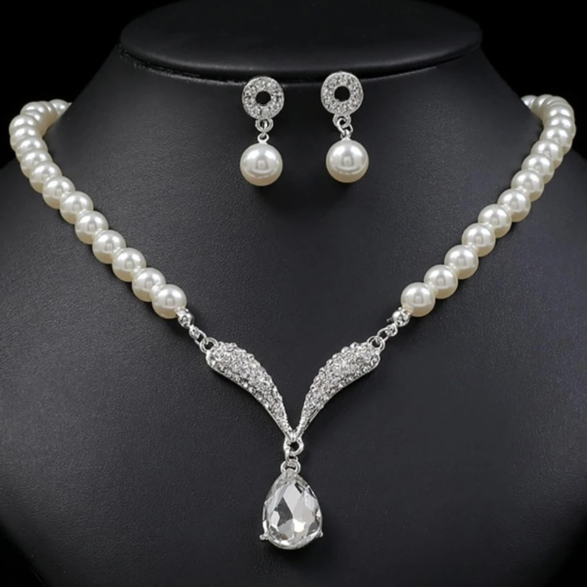 Gold jewelry set with pearl droplet necklace and matching earrings from Mohammad Collection, perfect for weddings and special occasions.